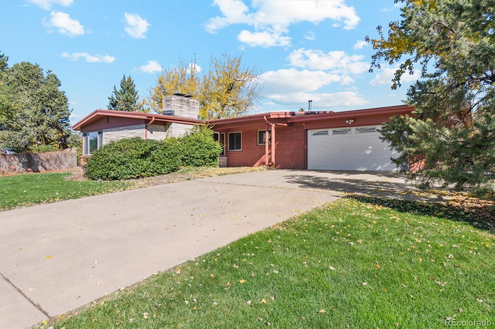 20 Rangeview Place Wheat Ridge, CO 80215 - Photo 10 of 49 a front view of a house with a yard and trees