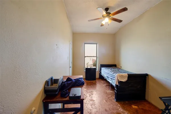 a living room with furniture and a ceiling fan
