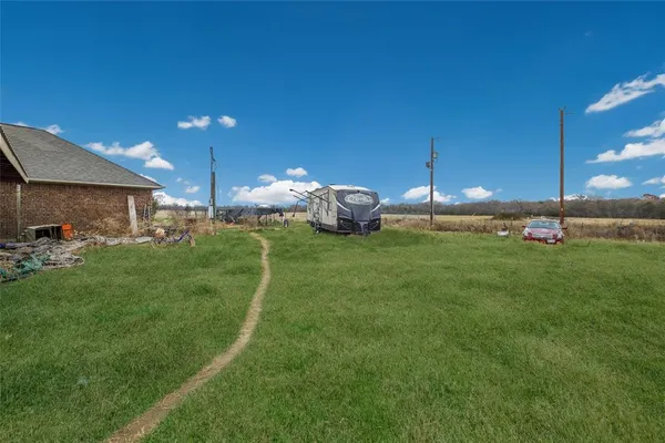 a view of a house with a backyard and sitting area