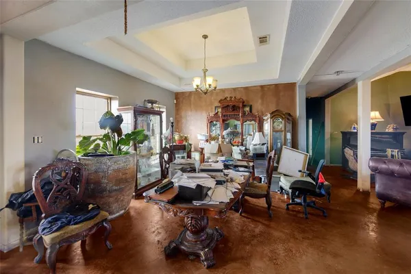 a living room with lots of furniture and a chandelier
