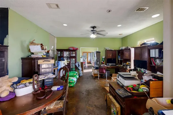 a living room with lots of furniture and kitchen view