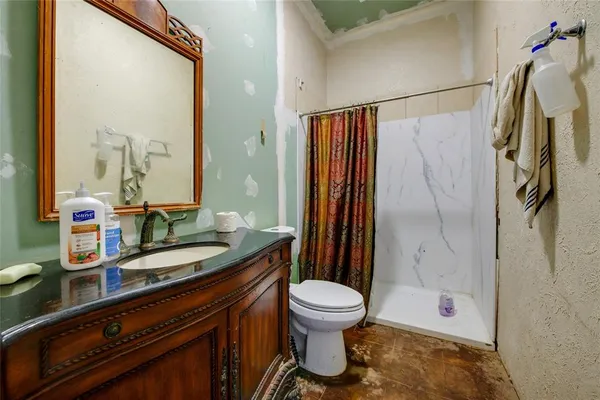 a bathroom with a granite countertop sink toilet and shower