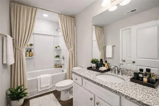 a bedroom with a bed and a dresser next to a window