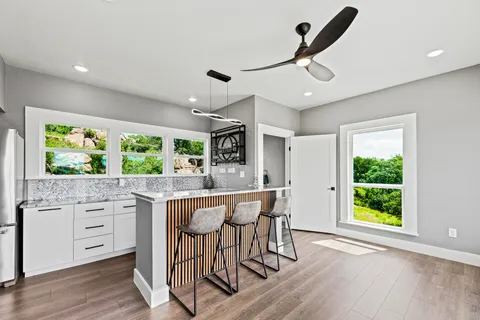 a kitchen with stainless steel appliances granite countertop a stove and a wooden floors