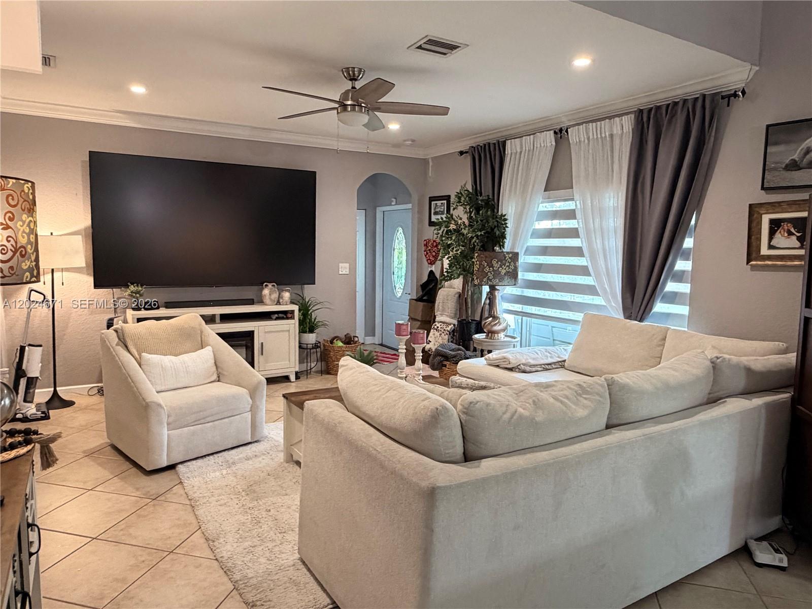 2116 Northeast 38th Road, Unit 2116 Homestead, FL 33033 - Photo 27 of 31 a living room with furniture and a flat screen tv