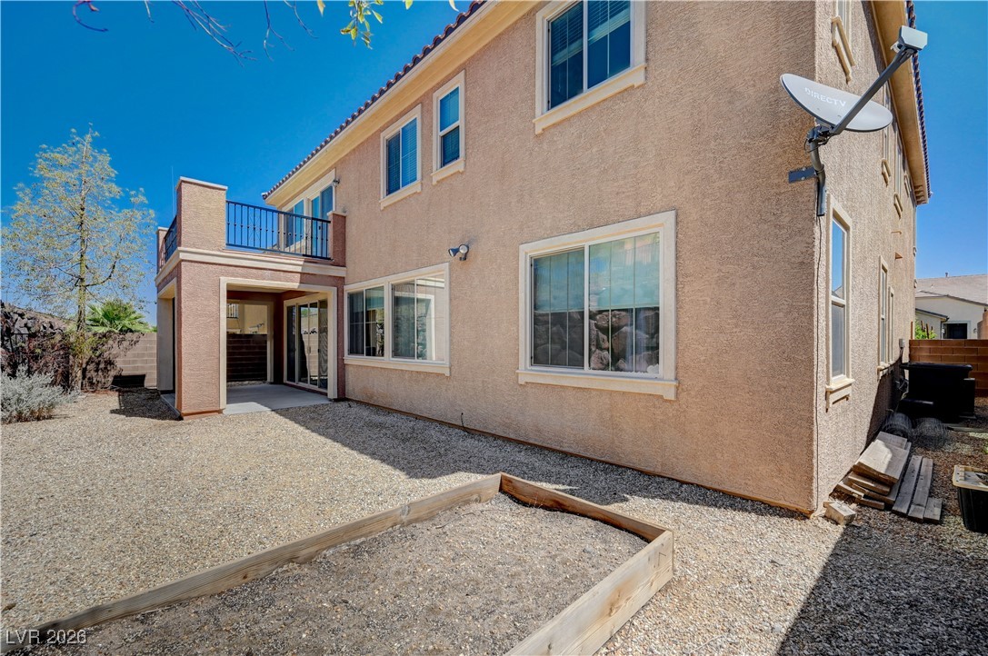929 Pomander Point Place Henderson, NV 89012 - Photo 60 of 60 Rear view of house featuring a patio area, a fenced backyard, stucco siding, a balcony, and a garden