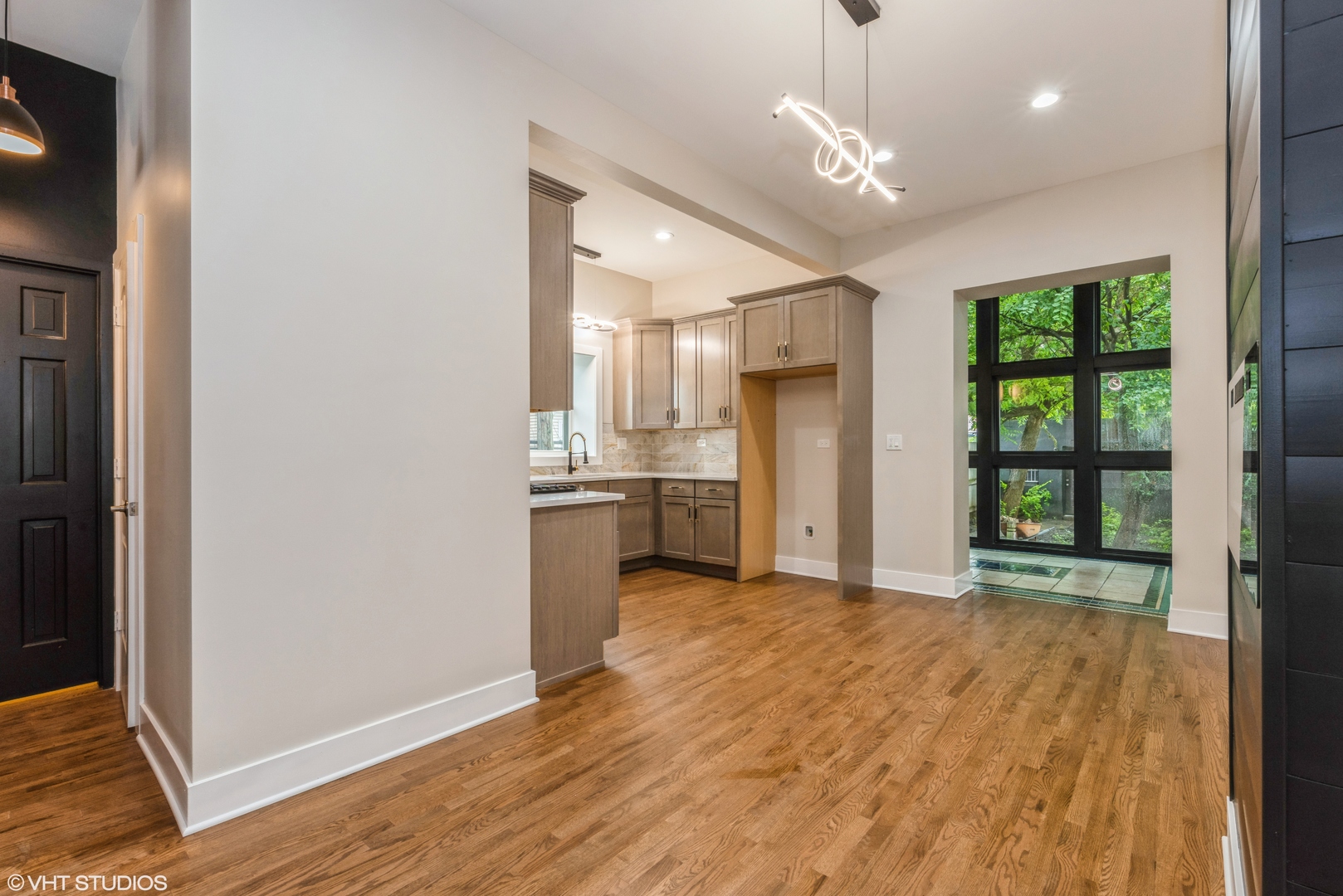 2452 West Lexington Street Chicago, IL 60612 - Photo 6 of 15 a view of a kitchen with wooden floor and a ceiling fan