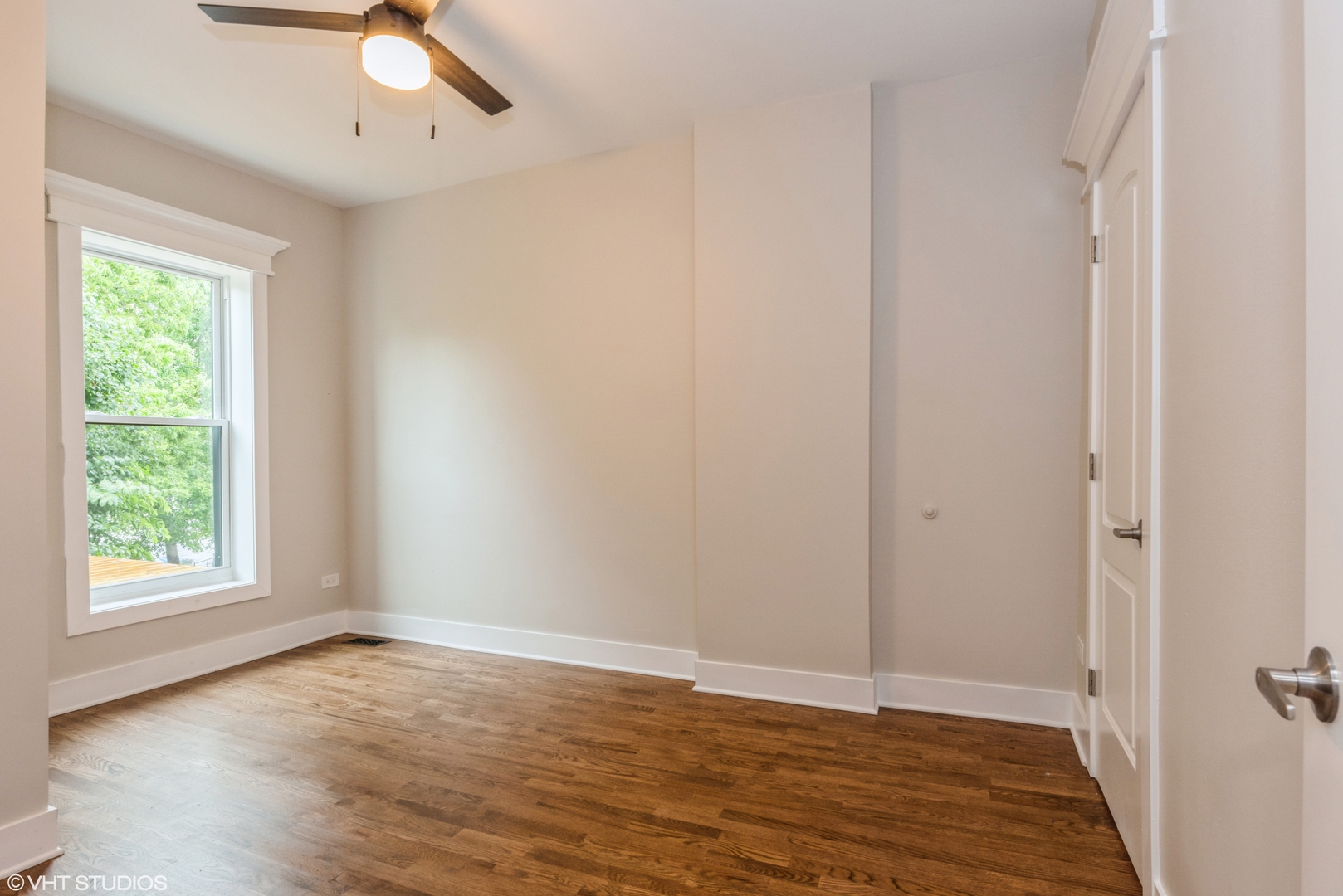 2452 West Lexington Street Chicago, IL 60612 - Photo 10 of 15 a view of an empty room with wooden floor and window
