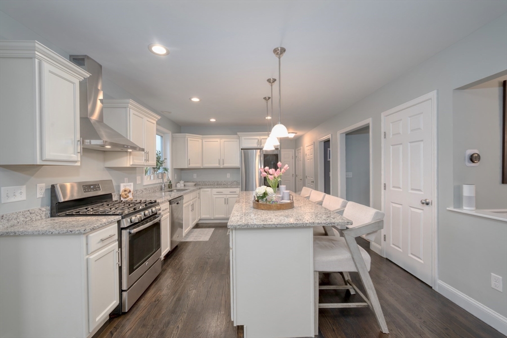 4 Sycamore Lane Bridgewater, MA 02324 - Photo 11 of 42 a kitchen with a table chairs stove and cabinets