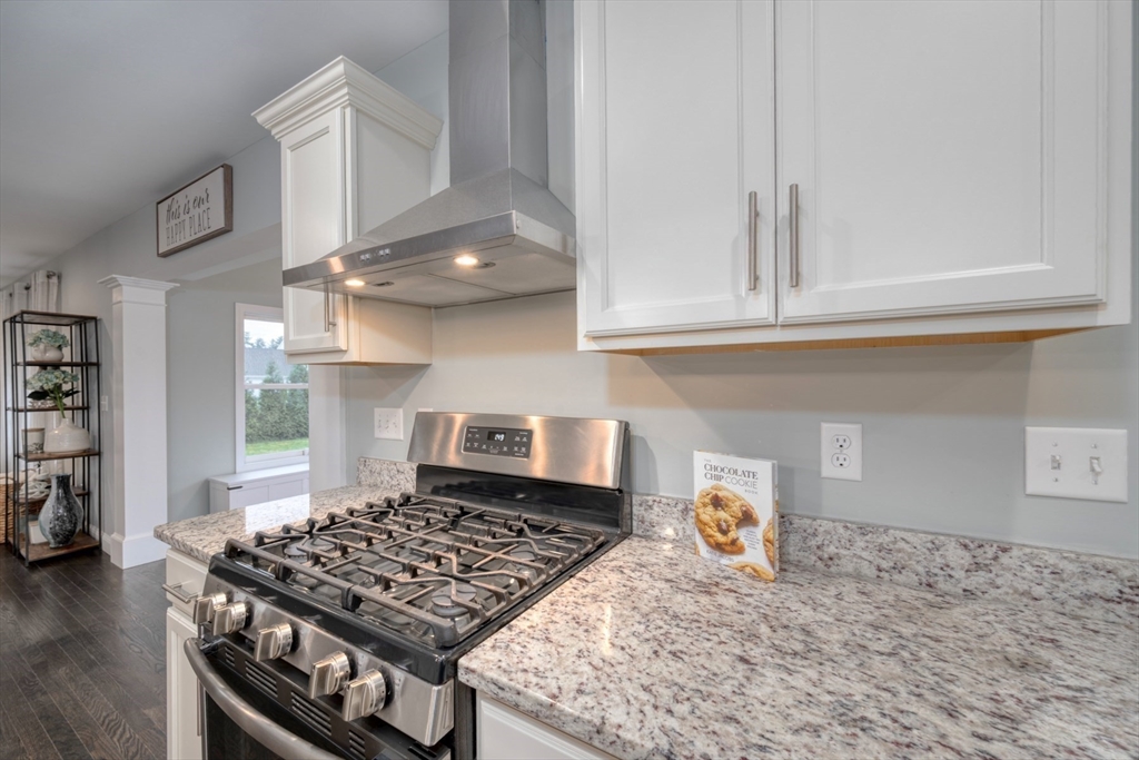 4 Sycamore Lane Bridgewater, MA 02324 - Photo 12 of 42 a kitchen with a stove and a white cabinets