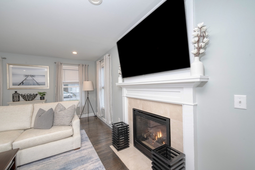 4 Sycamore Lane Bridgewater, MA 02324 - Photo 20 of 42 a living room with furniture a flat screen tv and a fireplace