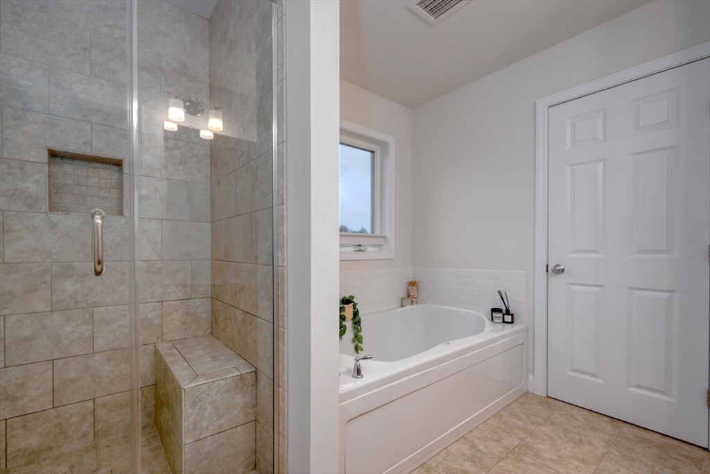 4 Sycamore Lane Bridgewater, MA 02324 - Photo 25 of 42 a white bath tub sitting next to a white sink and vanity