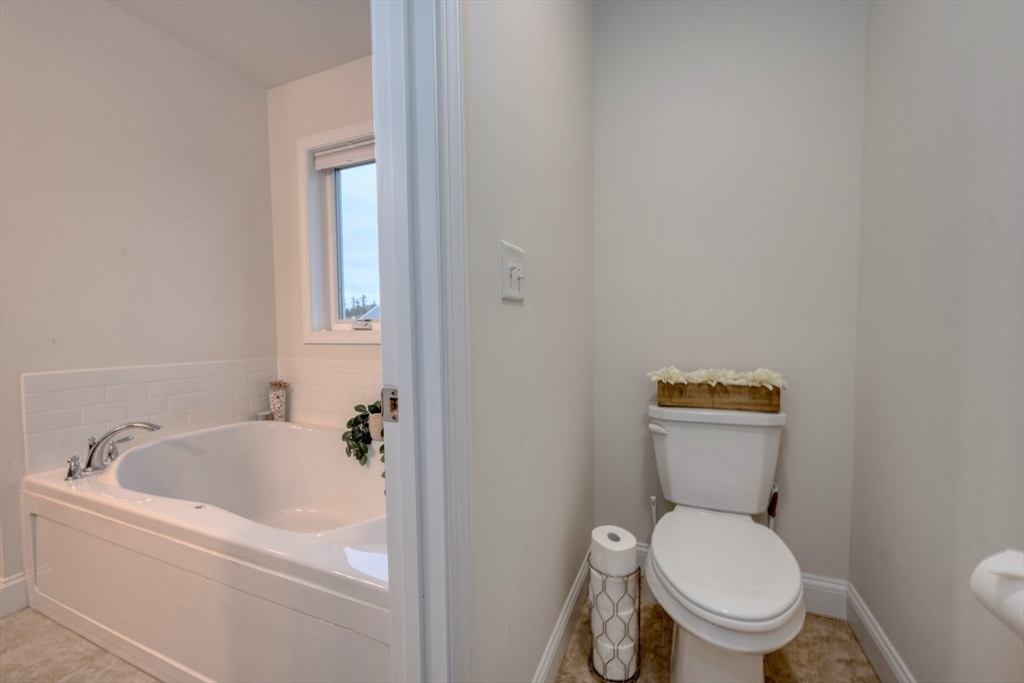 4 Sycamore Lane Bridgewater, MA 02324 - Photo 26 of 42 a white toilet sitting next to a bath tub