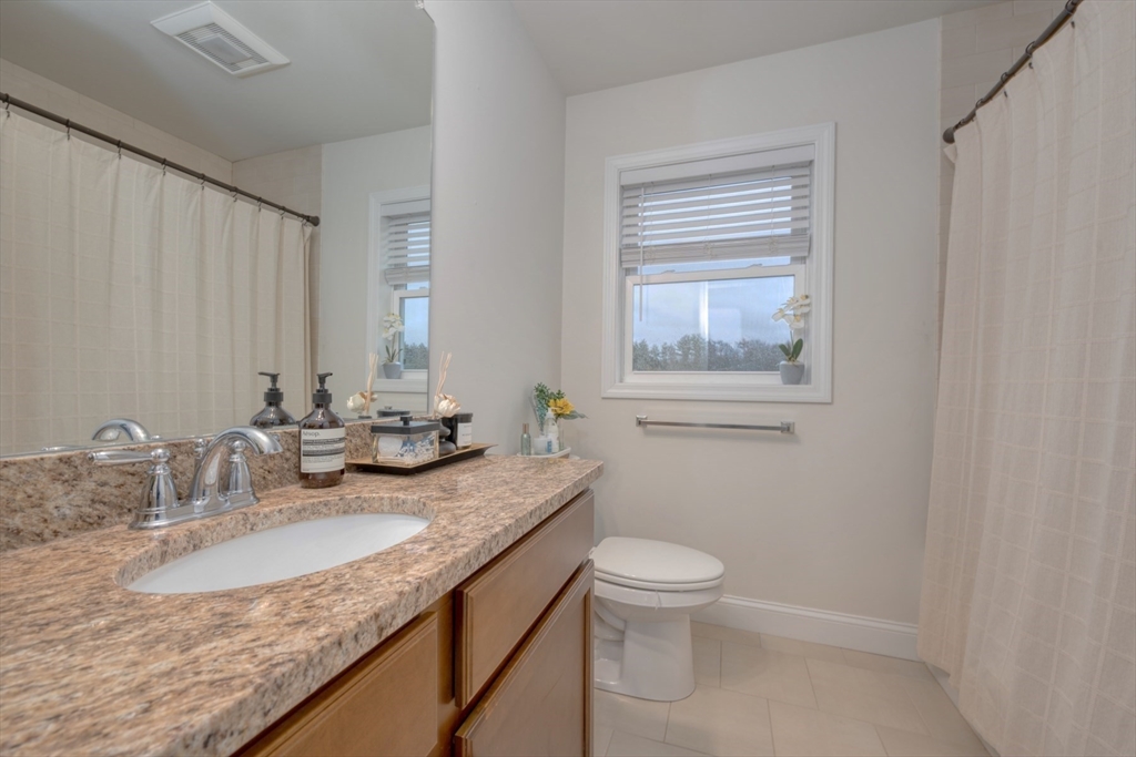 4 Sycamore Lane Bridgewater, MA 02324 - Photo 29 of 42 a bathroom with a granite countertop sink a toilet and a mirror