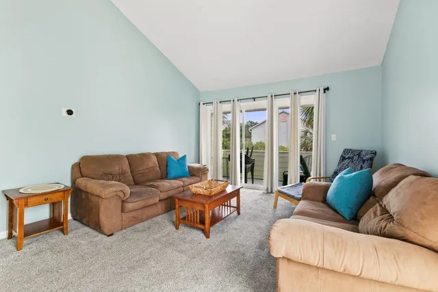 a view of a hallway and a livingroom with furniture