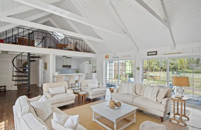 a view of a a dining room with furniture window and wooden floor