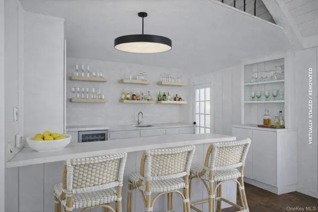 a kitchen with stainless steel appliances granite countertop a dining table and chairs with wooden floor