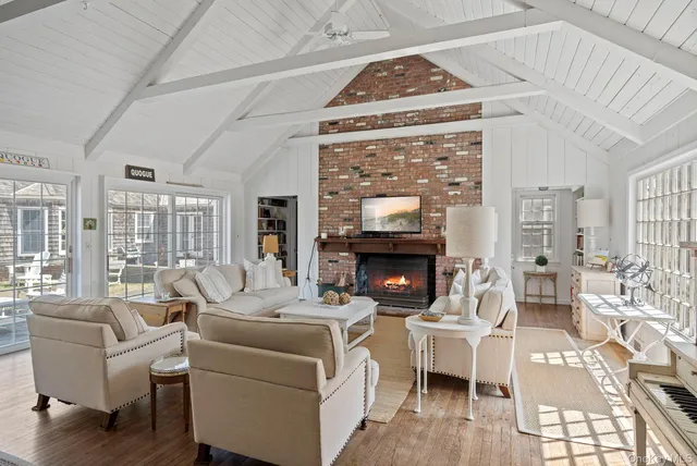 a living room with furniture a fireplace and a flat screen tv