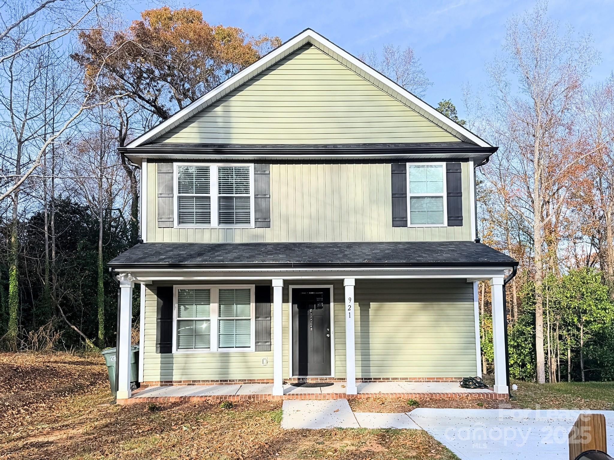 921 Pineridge Street Southeast Concord, NC 28025 - Photo 1 of 13 a front view of a house with a garden