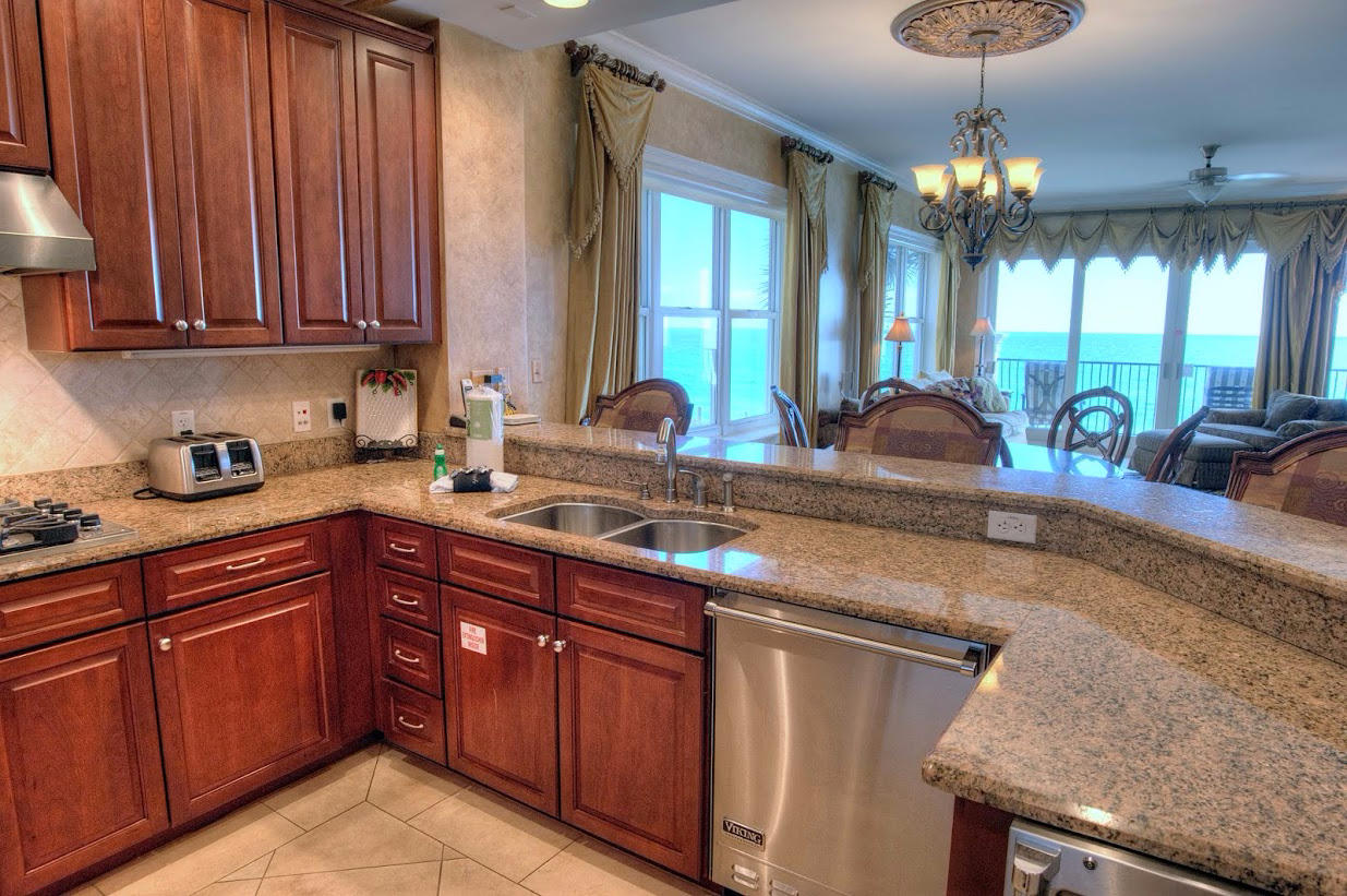 2421 West County Highway 30A, Unit C201 Santa Rosa Beach, FL 32459 - Photo 13 of 50 a kitchen with granite countertop a sink stainless steel appliances and cabinets