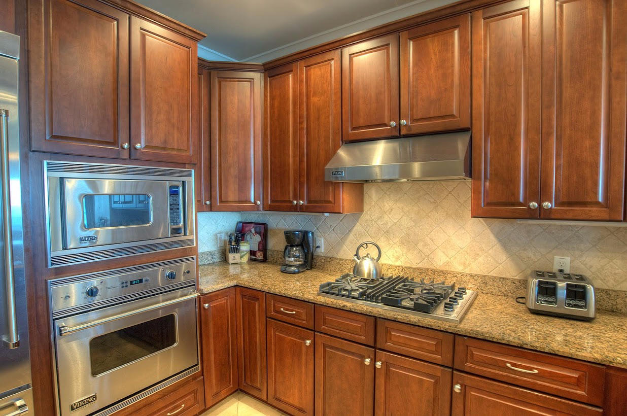 2421 West County Highway 30A, Unit C201 Santa Rosa Beach, FL 32459 - Photo 15 of 50 a kitchen with granite countertop cabinets stainless steel appliances and a sink