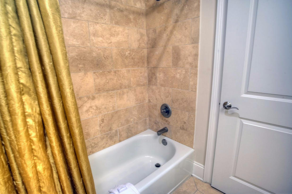 2421 West County Highway 30A, Unit C201 Santa Rosa Beach, FL 32459 - Photo 30 of 50 a bathroom with a tub and shower curtain