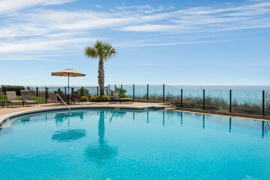 2421 West County Highway 30A, Unit C201 Santa Rosa Beach, FL 32459 - Photo 42 of 50 a view of a swimming pool with table and chairs