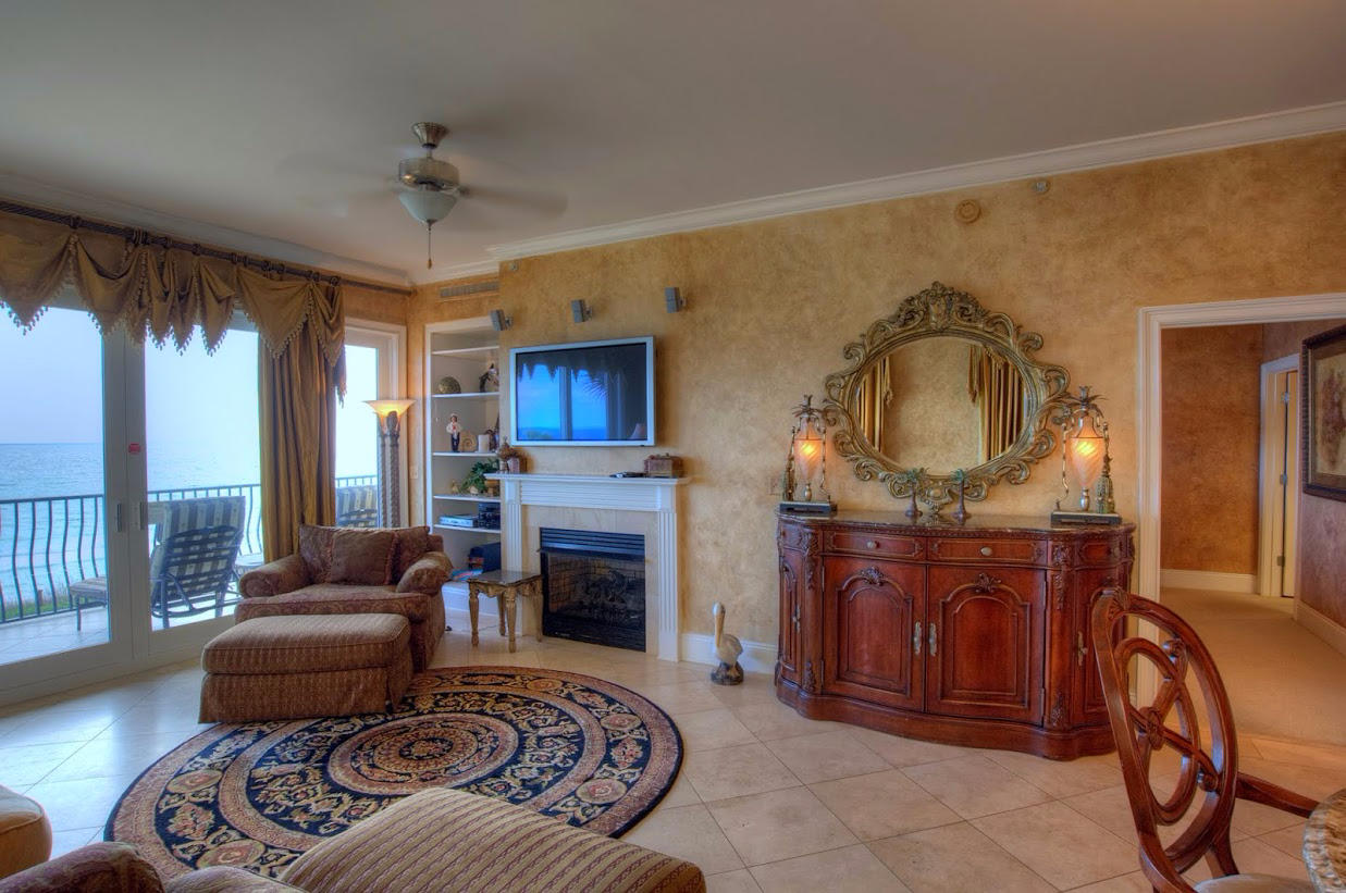 2421 West County Highway 30A, Unit C201 Santa Rosa Beach, FL 32459 - Photo 7 of 50 a living room with furniture a fireplace and a flat screen tv