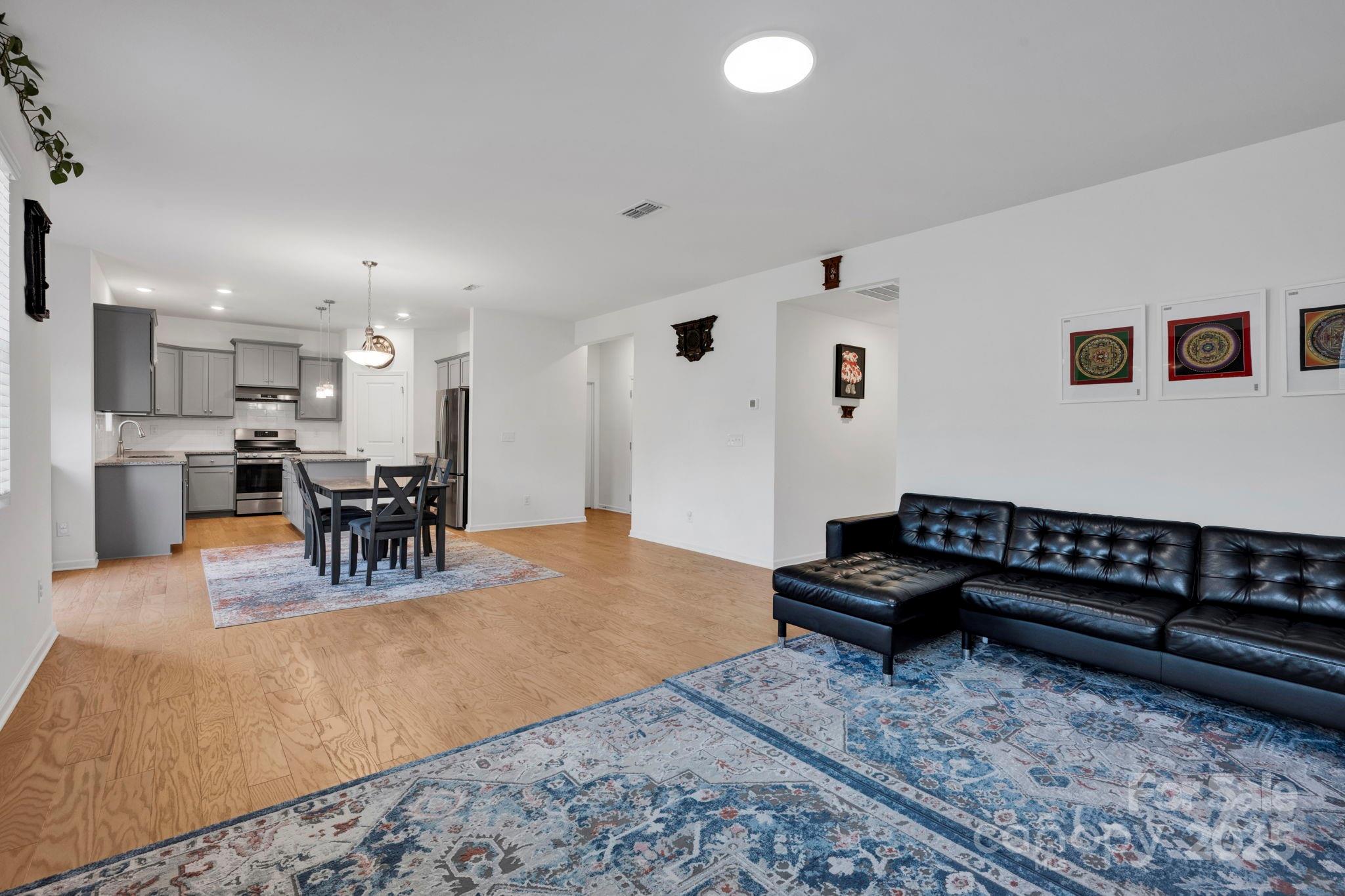 2712 Trinity Street Monroe, NC 28110 - Photo 13 of 48 a living room with furniture and kitchen view