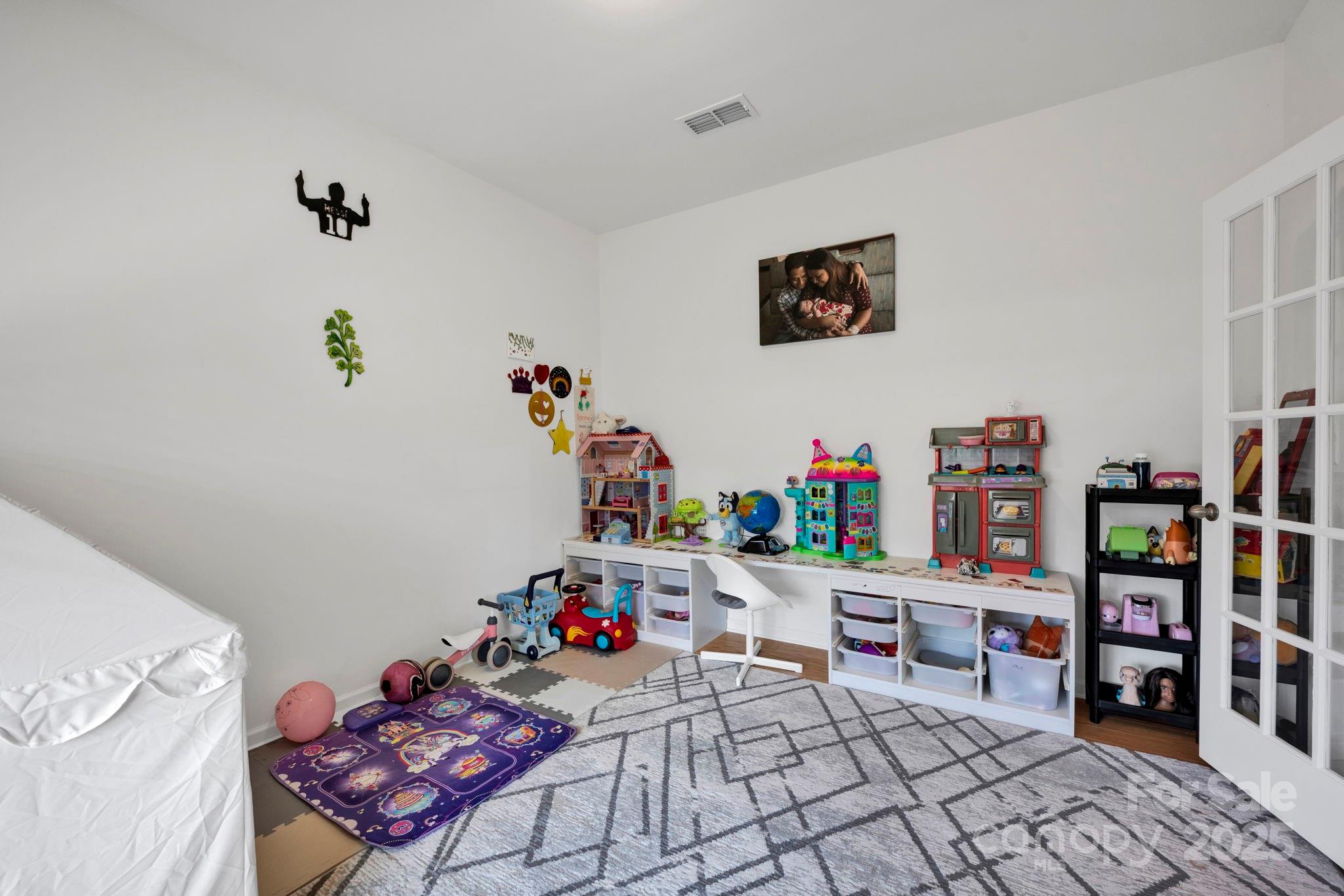 2712 Trinity Street Monroe, NC 28110 - Photo 18 of 48 a playing room with furniture and a book shelf