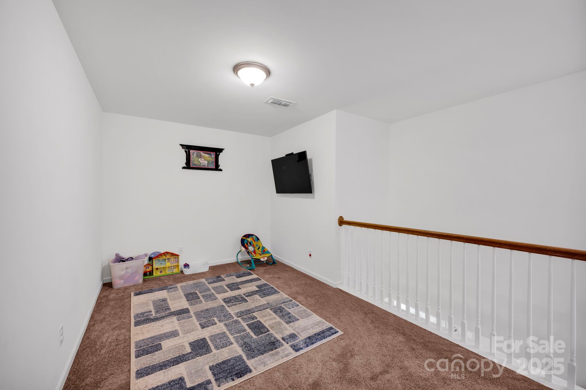2712 Trinity Street Monroe, NC 28110 - Photo 21 of 48 a bed room with a bed and a flat screen tv
