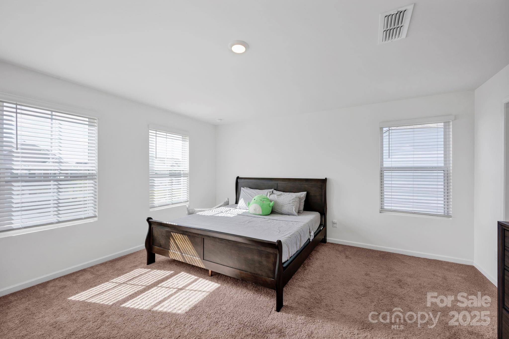 2712 Trinity Street Monroe, NC 28110 - Photo 23 of 48 a bedroom with a bed lamp and window