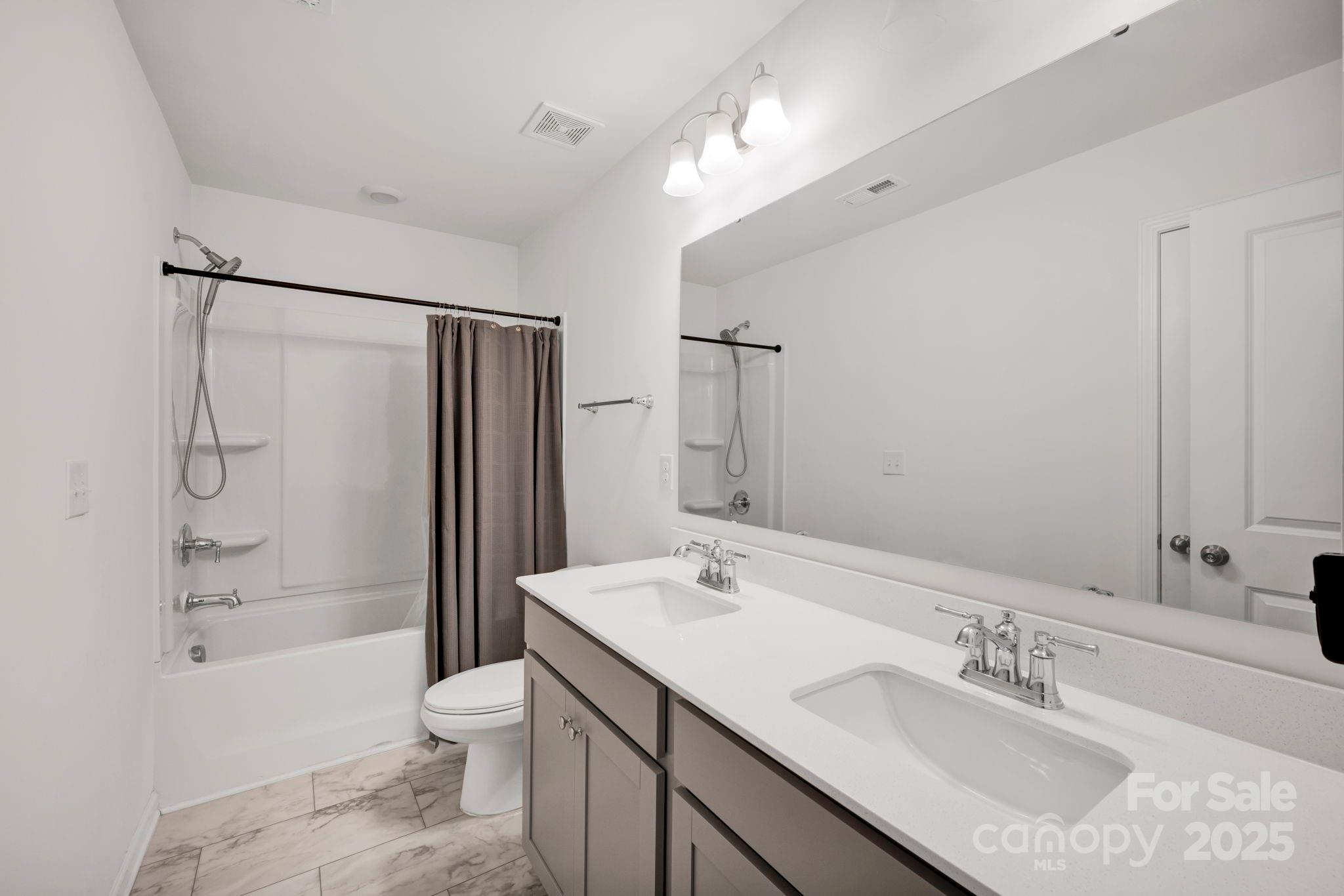 2712 Trinity Street Monroe, NC 28110 - Photo 25 of 48 a bathroom with a sink toilet double vanity and shower