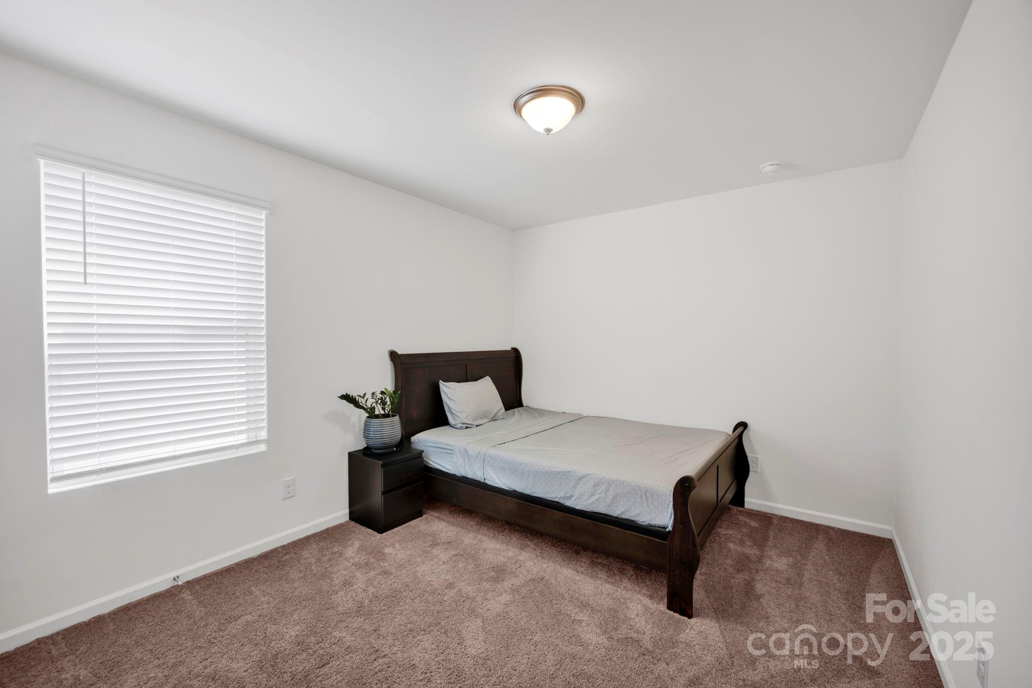 2712 Trinity Street Monroe, NC 28110 - Photo 28 of 48 a bedroom with a bed and window