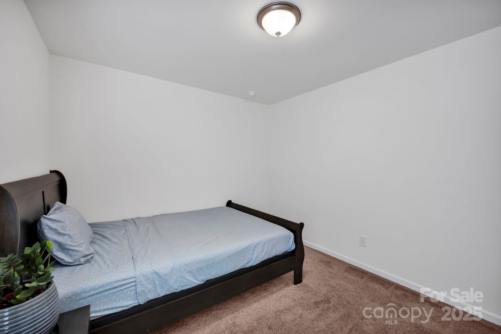 2712 Trinity Street Monroe, NC 28110 - Photo 30 of 48 a bedroom with a bed and a window