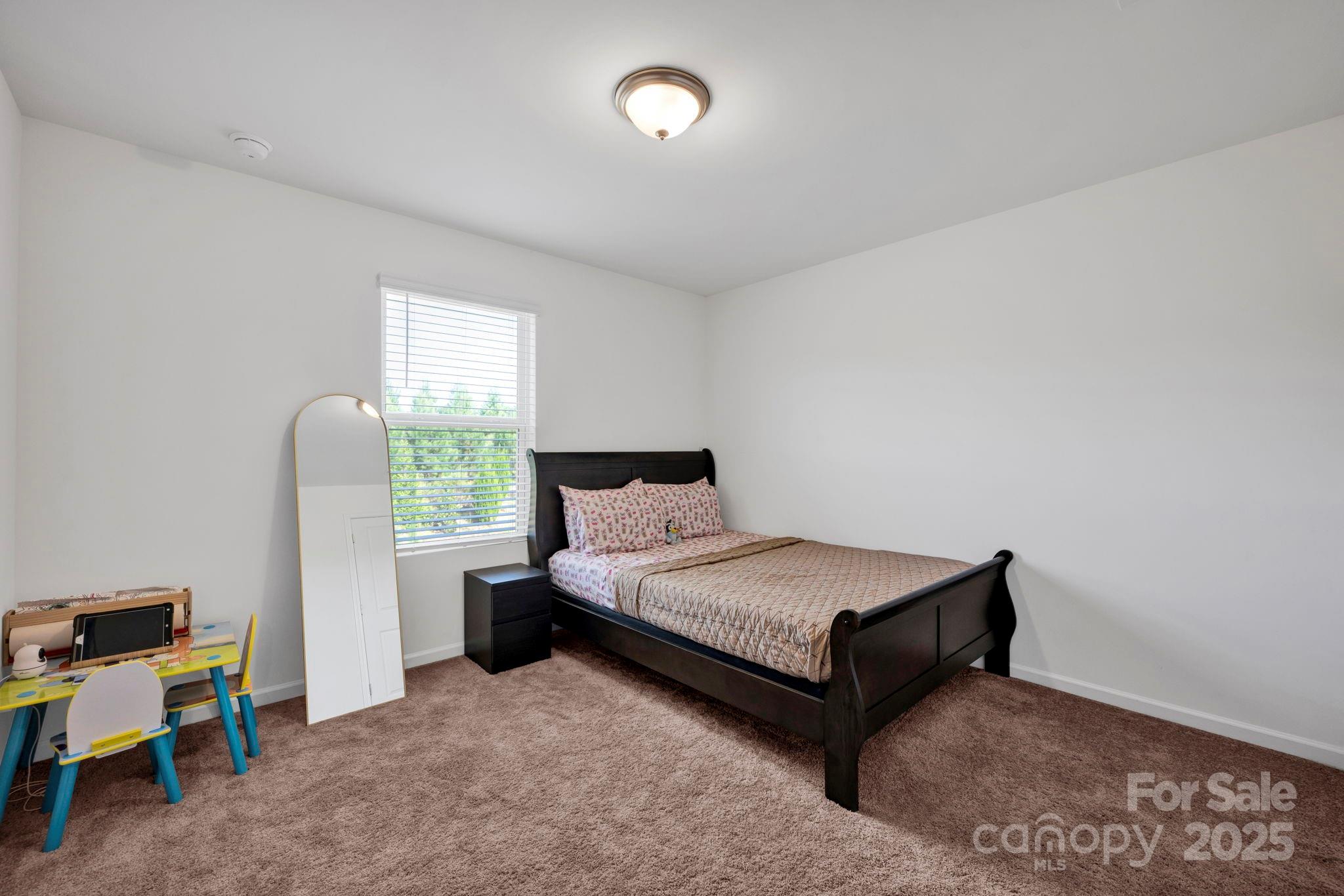 2712 Trinity Street Monroe, NC 28110 - Photo 34 of 48 a bedroom with a bed and a window