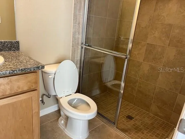 a white toilet sitting next to a bathroom sink