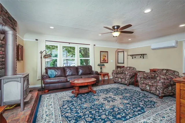 a bedroom with furniture and a large window