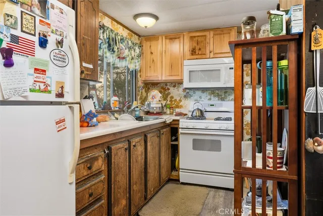 a view of a patio with table and chairs with wooden fence and plants