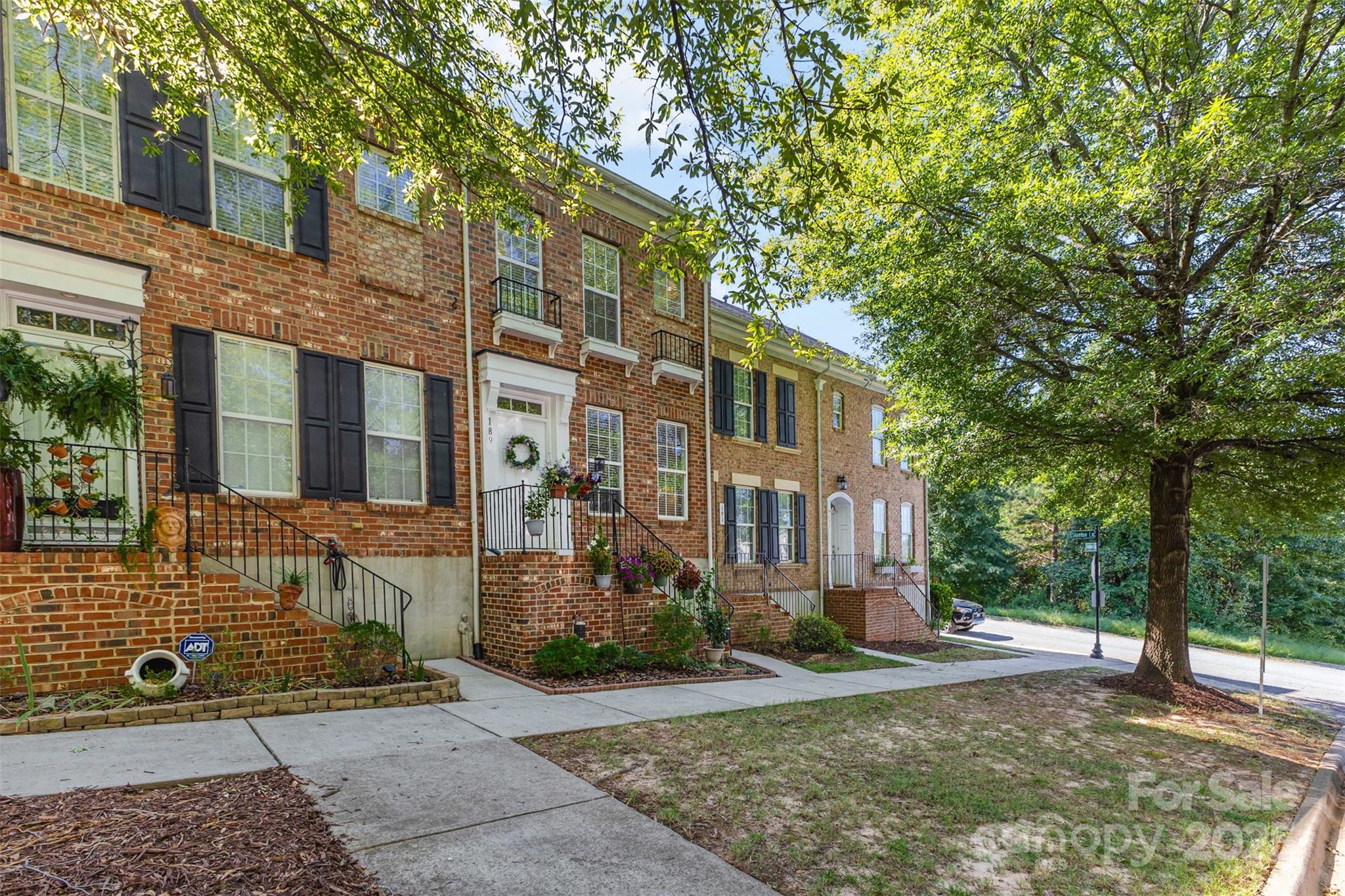 a view of a brick building next to a yard