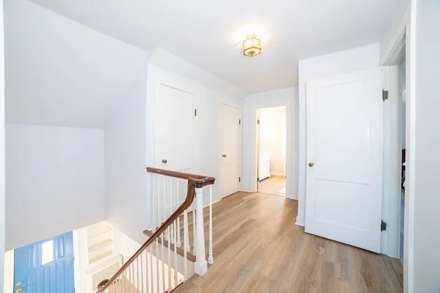 a bedroom with a bed a window and a potted plant