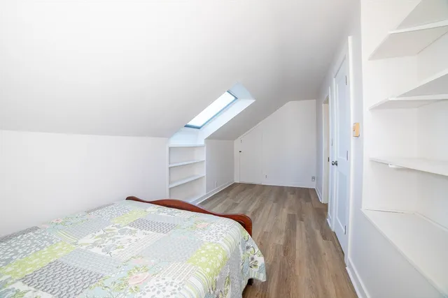 a living room with a bed and a walk in closet