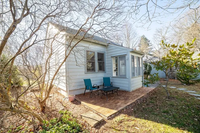 a view of a house with a yard covered in snow
