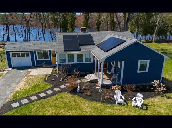 a view of a house with backyard outdoor seating area and furniture