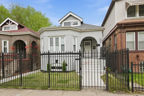 a view of a house with a iron gate