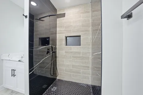 a bathroom with a sink a toilet and shower
