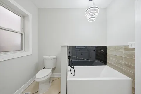 a bathroom with a bathtub and a toilet