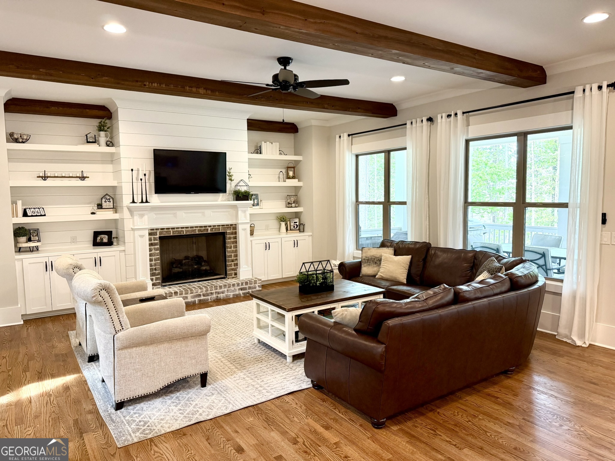 120 Spring Creek Drive Rutledge, GA 30663 - Photo 7 of 38 a living room with furniture a flat screen tv and a fireplace