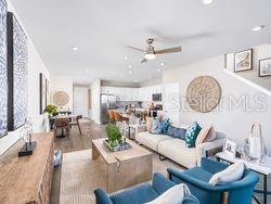4519 Trinity Way, Unit THC1 Kissimmee, FL 34746 - Photo 6 of 14 a living room with furniture a clock and a view of bathroom