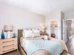 4519 Trinity Way, Unit THC1 Kissimmee, FL 34746 - Photo 8 of 14 a bedroom with a bed and a lamp
